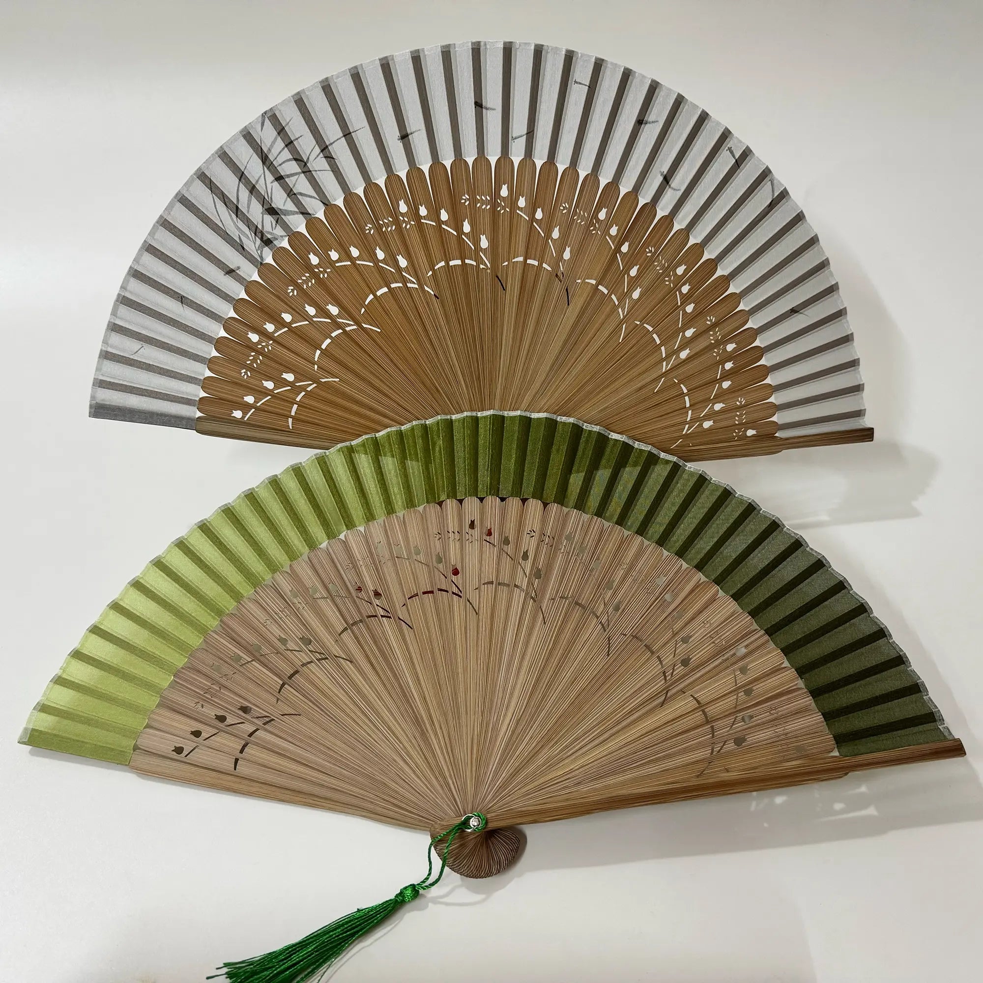2 Pomegranate flower carved bamboo folding fans.