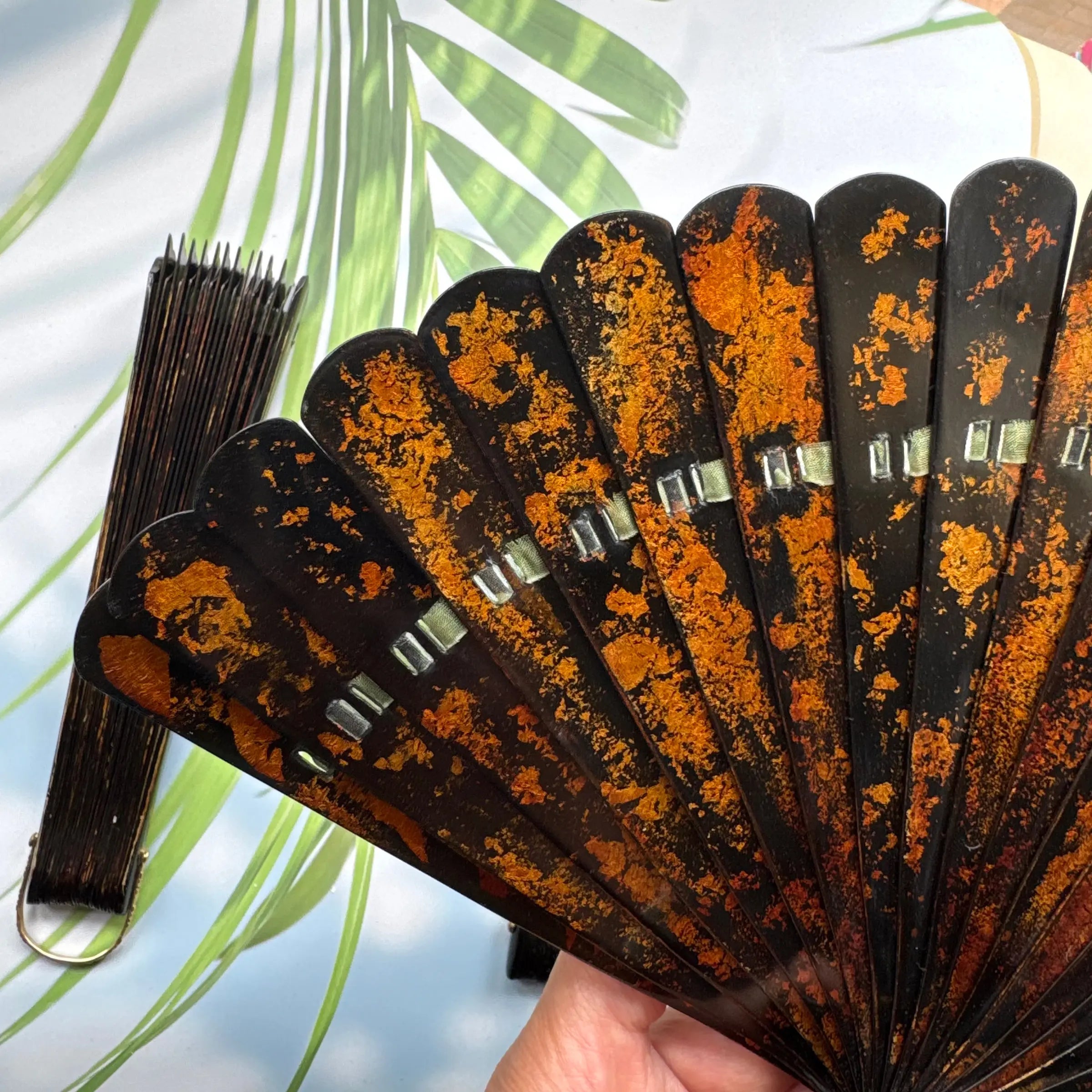 Details of the gold-sprinkled patterns of an East Asian lacquer folding fan (Urushi fan).