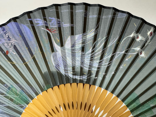 Details of the phoenix printed on a Chinese silk phoenix folding fan.