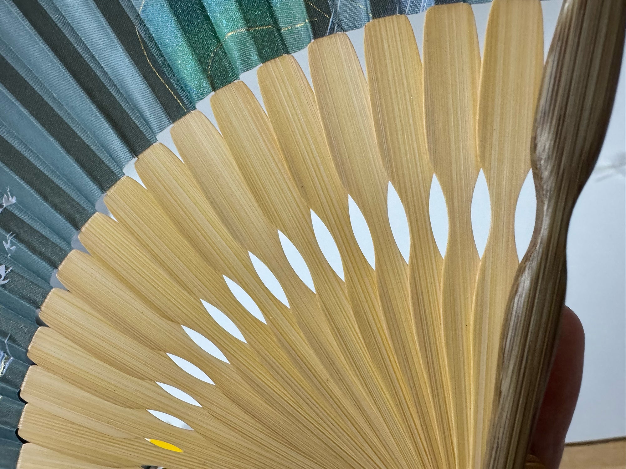 Details of fan frame of a Chinese silk phoenix folding fan