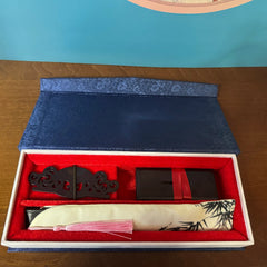 a dark blue box with surface patterns, containing a fan and a fan stand holder inside