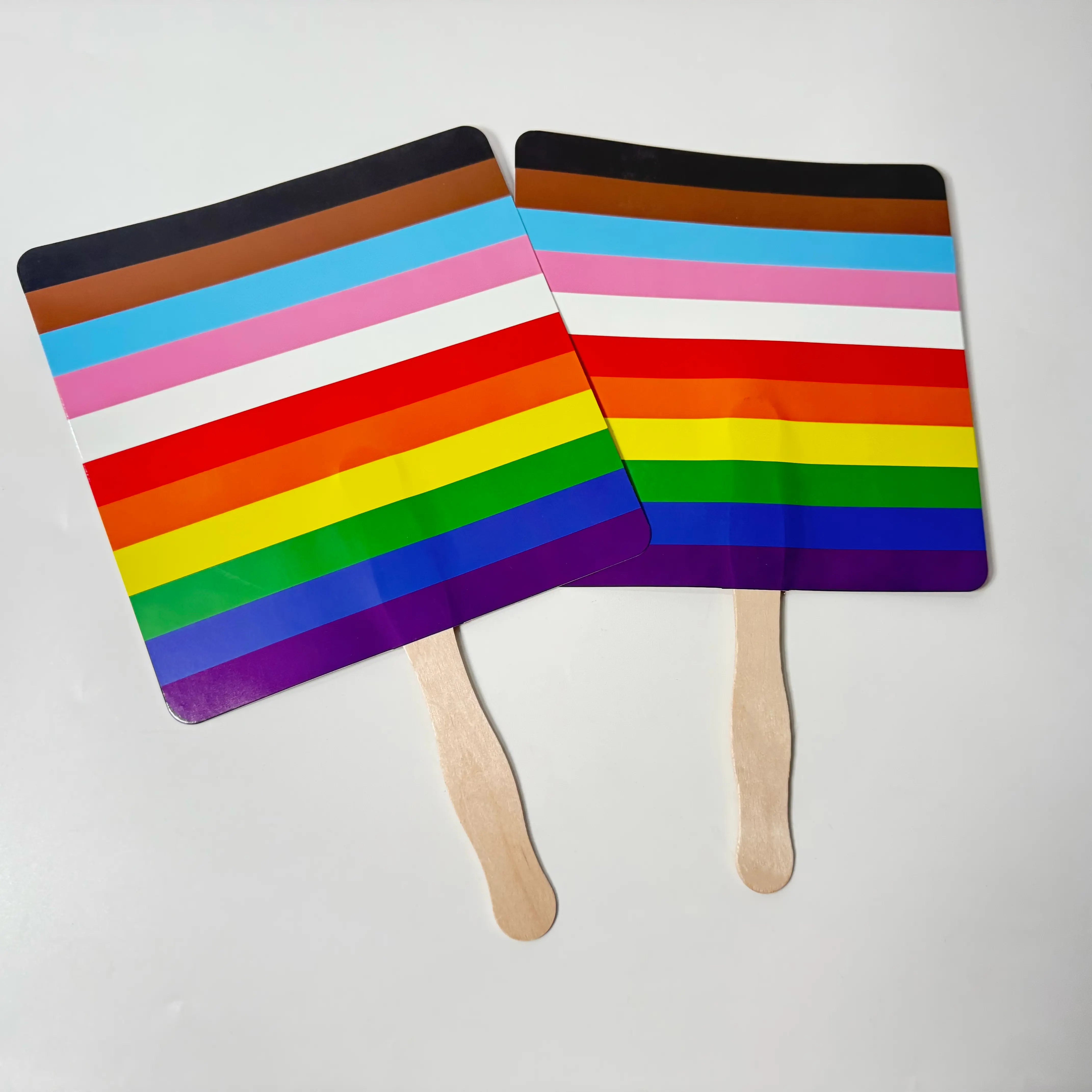 Pair of rainbow custom printed promotional hand fans on white background. Perfect for Pride parades, LGBTQ+ events, and festivals.