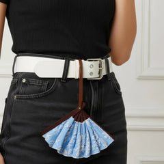 Classical embroidery hand fan styled as a fashion accessory: leather strap wrapped around a model's belt.