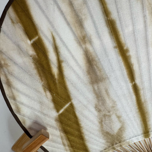 Details of a Japanese round fan with bamboo brown tie-dye print.