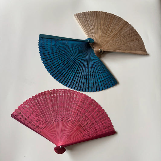 3 touqing bamboo folding fans on a white table
