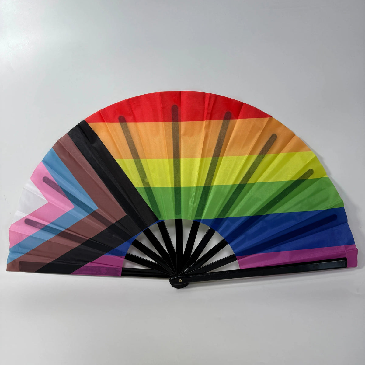 Vibrant rainbow clacking fan, perfect for dance props, rave events, and line dancing (like the "Boots on the Ground" routine).