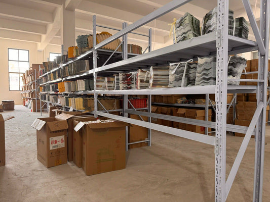 A large collection of assorted decorative fans neatly stored in a warehouse.