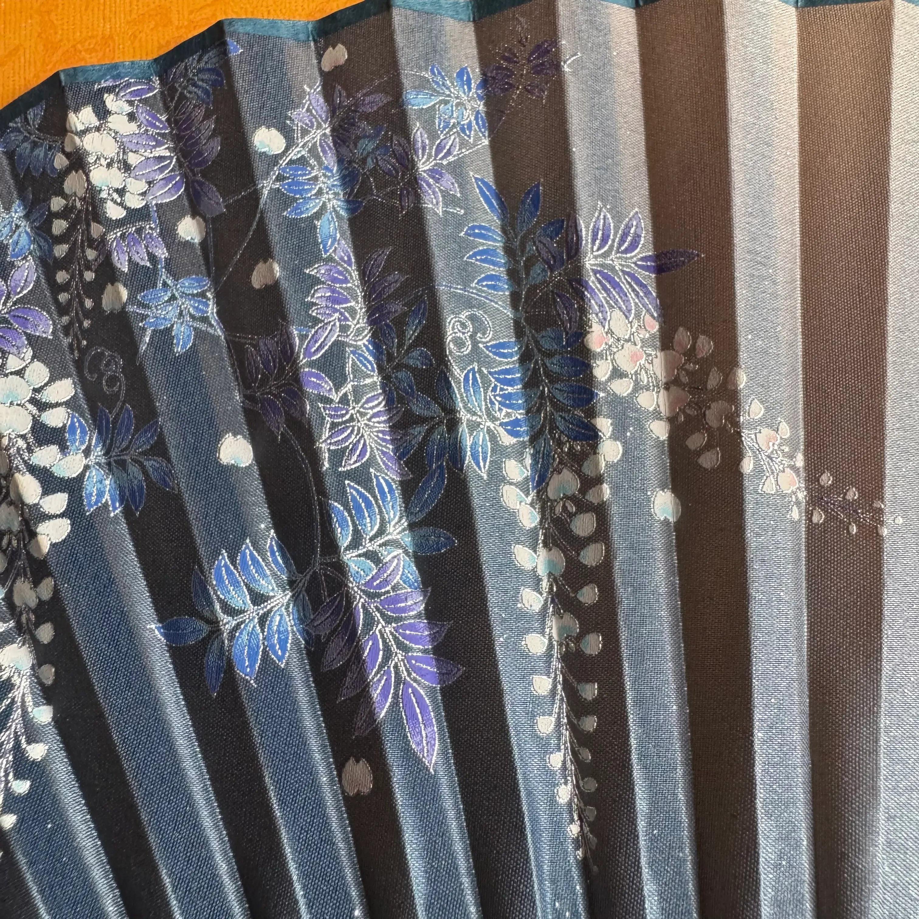 Details of a Chinese bamboo folding fan: beautiful wisteria patterns